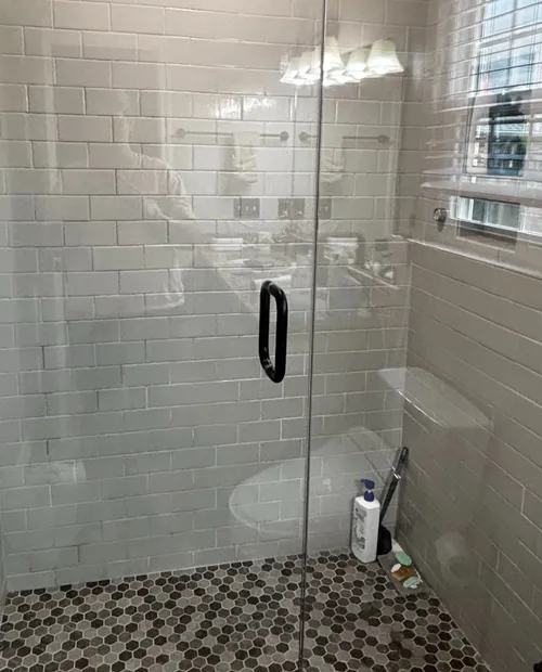 Spotless glass shower enclosure after cleaning